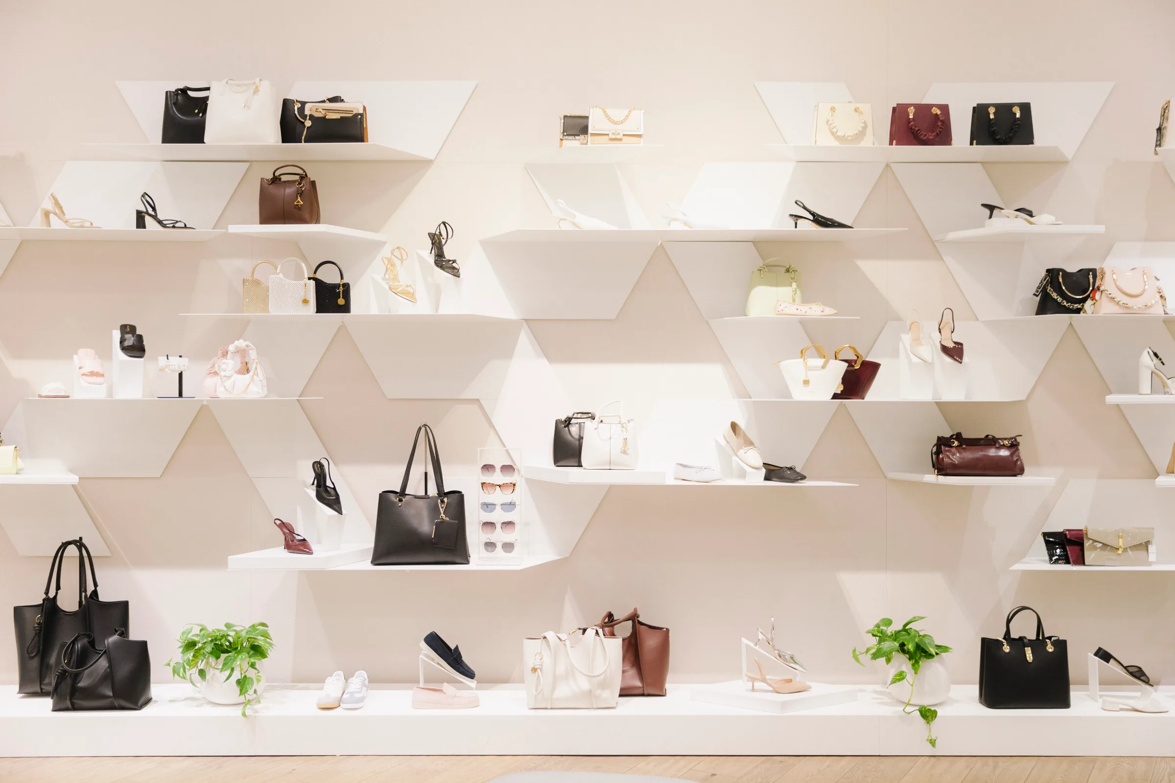 Fiddle Leaf Fig tree with sage green seating in bright Aldo shoe store at Yorkdale