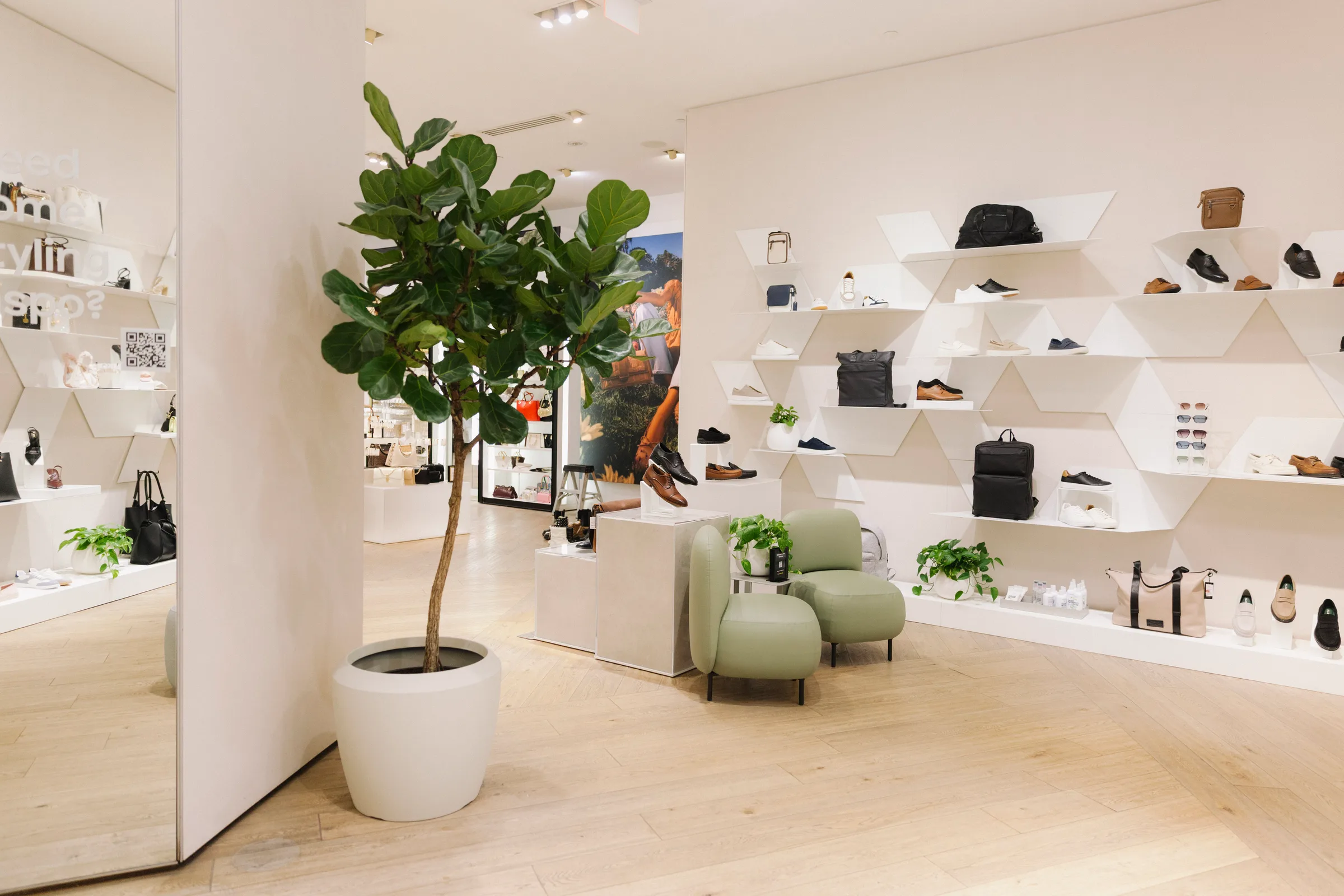 Wide view of Aldo Yorkdale store with Fiddle Leaf Fig and Pothos throughout retail space
