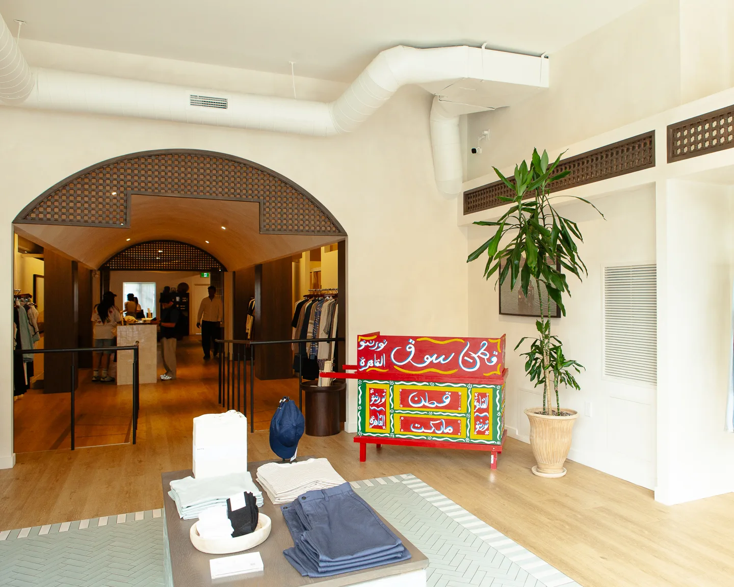 Arched doorway with mashrabiya screen, colorful Egyptian bench and Dracaena at KOTN Ossington