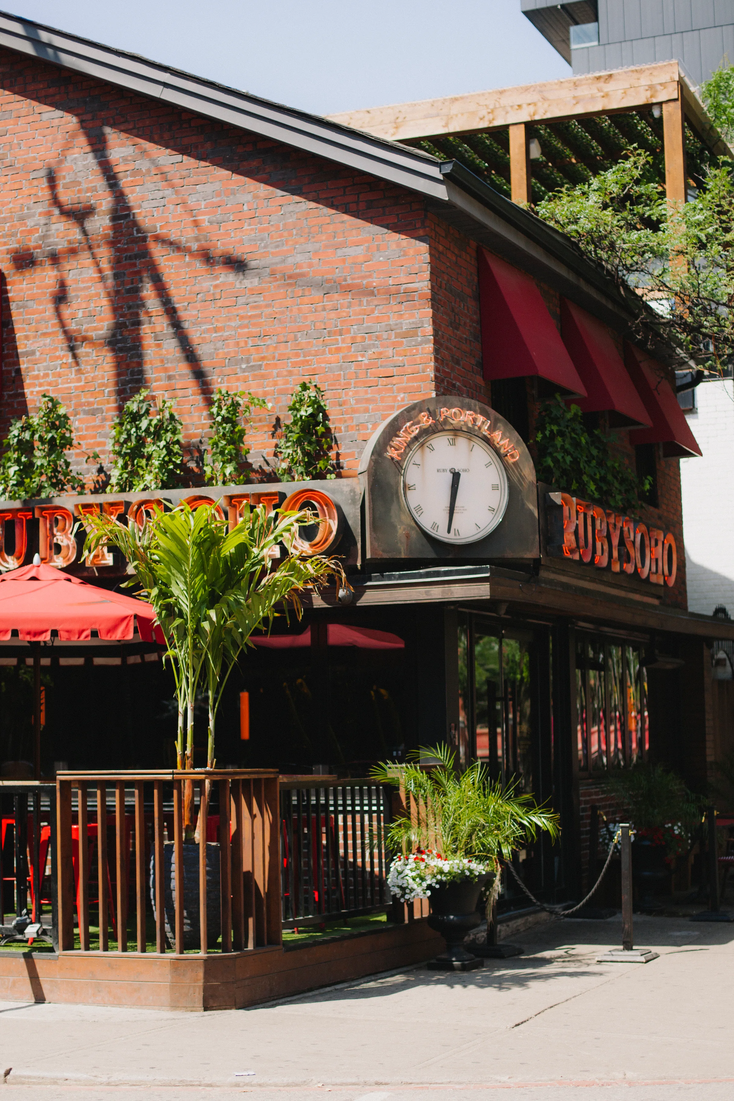 Ruby Soho exterior with brick facade and tropical planters